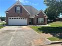 Brick home with attached garage on a sunny day at 1266 Laurelwood Ct, Lawrenceville, GA 30045