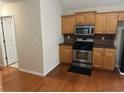 Kitchen featuring wood cabinets, stainless steel appliances, and hardwood flooring at 1266 Laurelwood Ct, Lawrenceville, GA 30045