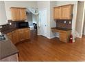 A kitchen with warm-toned cabinets, hardwood floors and stainless appliances at 1266 Laurelwood Ct, Lawrenceville, GA 30045