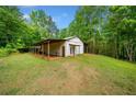 Large outbuilding offers ample storage and workspace, perfect for hobbies or equipment at 500 Nolan Rd, Carrollton, GA 30116