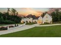 Luxury home exterior featuring a meticulously landscaped yard, modern architecture, and a circular driveway at , Buford, GA 30518