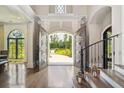 Grand foyer with a view of the backyard, showcasing elegant staircase and gorgeous wood floors at , Buford, GA 30518