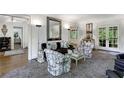 Sophisticated living room with unique patterned chairs, elegant decor, and lots of natural light at 3382 Habersham Rd, Atlanta, GA 30305
