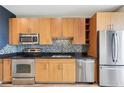 Well-equipped kitchen with stainless steel appliances, black granite countertops, and wood cabinets at 3400 Malone Dr # 303, Atlanta, GA 30341