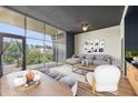 Bright living area featuring hardwood floors, oversized windows, and balcony access at 3400 Malone Dr # 303, Atlanta, GA 30341