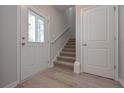 Welcoming entryway with wood floors, stairway, and natural light at 16 Deer Place, Villa Rica, GA 30180