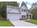 Side view of home featuring neutral siding, and a large 2 car attached garage at 16 Deer Place, Villa Rica, GA 30180