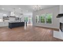Open floorplan showcasing the spacious kitchen with an island and large windows at 6830 Heard Ln, Cumming, GA 30041