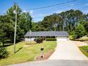 Inviting home features a well-kept lawn, mature trees, and an ample driveway at 35 Brooke Holw, Covington, GA 30016