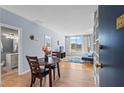 Cozy living room with wood floors, dining area, blue accent wall, and a view from the large window at 1421 Peachtree Ne St # 304, Atlanta, GA 30309