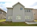 Rear view of a two-story home with gray siding and multiple windows overlooking the backyard at 2522 Bear Mountain St, Lithonia, GA 30058