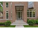 Close-up of a brick home entrance, showcasing the grand door, stone steps, and professional landscaping at 27 Maddox Ne Dr, Atlanta, GA 30309