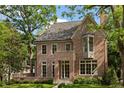 Charming brick home with mature trees, well-manicured lawn, and inviting facade at 27 Maddox Ne Dr, Atlanta, GA 30309
