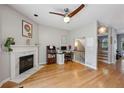 Cozy living room featuring hardwood floors, a fireplace, a ceiling fan, and a staircase at 576 Fraser Se St, Atlanta, GA 30312