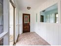 Cozy sunroom with tiled floor and a decorative front door at 3125 Cardinal Lake Cir, Duluth, GA 30096