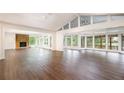 Spacious living area with hardwood floors, stone fireplace, and bright sunroom at 3125 Cardinal Lake Cir, Duluth, GA 30096