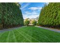 A perfectly manicured lawn leads up to the distinguished home, framed by tall, mature trees at 3450 Ridgewood Nw Rd, Atlanta, GA 30327
