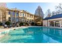 A view of the in-ground pool, lounge chairs, and umbrella at the back of the residence at 3450 Ridgewood Nw Rd, Atlanta, GA 30327