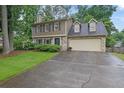 Charming two-story home featuring stone accents, a two-car garage, and a well-manicured front lawn at 3470 Whisperwood Nw Ct, Marietta, GA 30064