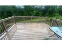 A spacious wooden deck offers an inviting outdoor living space with a weathered finish, perfect for relaxation at 585 Station View Run, Lawrenceville, GA 30043