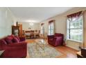 Formal living room featuring hardwood floors, large windows, neutral walls, and a dining area for entertaining guests at 2175 Fisher Ne Trl, Atlanta, GA 30345