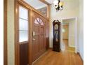 Entryway featuring hardwood floors, a wooden front door with glass panels, and a grandfather clock at 2315 Tuxedo Se Dr, Marietta, GA 30067