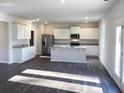 Open-concept kitchen features an island, stainless steel appliances, and white cabinets at 2701 Montie Ct, Lithia Springs, GA 30122