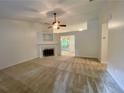 Bright living room featuring a fireplace and neutral carpet, providing a cozy and inviting atmosphere at 6026 Woodcreek Dr, Woodstock, GA 30188