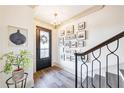 Light-filled foyer with hardwood floors, staircase, and gallery wall at 661 Auburn Ne Ave # 10, Atlanta, GA 30312
