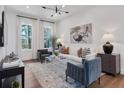 Bright living room featuring hardwood floors, a neutral palette, and lots of natural light at 1429 Hazy Way # 309, Atlanta, GA 30315