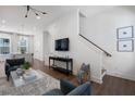 Open concept living room with hardwood floors and a view of the staircase at 1429 Hazy Way # 309, Atlanta, GA 30315
