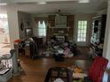 Living room with brick fireplace, hardwood floors, ceiling fan and natural light at 1481 Pine St, Stone Mountain, GA 30087