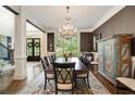 Formal dining room with chandelier, hardwood floors, and large windows for abundant natural light at 2870 Redding Ne Rd, Atlanta, GA 30319