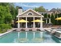 Resort-style pool with lounge chairs, sun umbrellas, and cabana featuring bar and outdoor seating at 2870 Redding Ne Rd, Atlanta, GA 30319