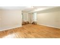 Expansive living room with hardwood floors, stair access, and natural light at 4201 Hicks Rd, Austell, GA 30106