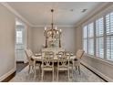 Elegant dining room with chandelier, plantation shutters, and neutral decor at 13055 Fox Rd, Alpharetta, GA 30005