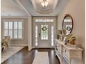 Welcoming foyer with dark hardwood floors and bright natural light at 13055 Fox Rd, Alpharetta, GA 30005
