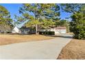 View of the home from the long driveway leading up to an attached two car garage at 140 Moseley Dr, Stockbridge, GA 30281