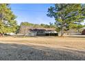 Ranch style home on a large lot with mature trees surrounding the home at 140 Moseley Dr, Stockbridge, GA 30281