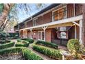 Beautiful backyard featuring a garden with manicured hedges, a wrought iron fence and a covered walkway at 3456 Paces Nw Pl, Atlanta, GA 30327