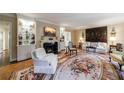Spacious living room with fireplace, built-in shelving, and an ornate area rug on the parquet wood floor at 3456 Paces Nw Pl, Atlanta, GA 30327