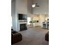 Open concept living room featuring a fireplace, high ceilings, and a seamless transition to the kitchen at 457 Panhandle Pl, Hampton, GA 30228
