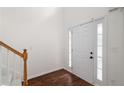 Entryway features hardwood flooring and a white front door with sidelights at 237 River Pass Ct, Dacula, GA 30019