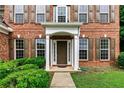 Close-up of a home's front door, showing brick facade and manicured bushes at 3153 Daleview Sw Way, Atlanta, GA 30331