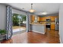 Eat-in kitchen featuring stainless steel appliances, tile backsplash, and sliding doors to the backyard at 411 Sugar Maple Ct, Canton, GA 30114