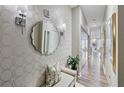Elegant hallway design featuring a decorative mirror, stylish sconces, and patterned wallpaper at 560 Dutch Valley Ne Rd # 2207, Atlanta, GA 30324