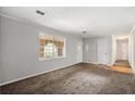 Bright living room featuring neutral paint, carpet floors, and natural light from a large window at 2830 Knollview Dr, Decatur, GA 30034