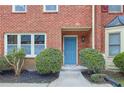 Brick townhome featuring landscaping, and walkway to the front door at 3144 Corner Oak Dr, Norcross, GA 30071