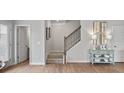 Inviting entryway featuring wood floors, staircase, and tasteful decorations at 14 Jacobs Farm Ln # 7, Lawrenceville, GA 30045