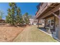 Private backyard featuring a lush lawn and mature trees, offering a serene outdoor escape at 3080 Westpoint Cir, Snellville, GA 30078